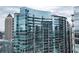 Exterior view of high-rise condo building with curved glass and multiple balconies, near downtown at 1080 Peachtree Ne St # 2108, Atlanta, GA 30309
