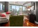 Modern living room with hardwood floors and city views from floor-to-ceiling windows at 1080 Peachtree Ne St # 2108, Atlanta, GA 30309