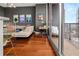 Open-concept space with hardwood floors, offering a living area and office with balcony access at 1080 Peachtree Ne St # 2108, Atlanta, GA 30309