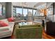 Bright living room featuring a comfortable sofa and floor-to-ceiling windows with beautiful views of the city skyline at 1080 Peachtree Ne St # 2108, Atlanta, GA 30309