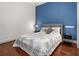 Main bedroom showcases a queen bed with side tables with lamps and a blue accent wall at 1080 Peachtree Ne St # 2108, Atlanta, GA 30309