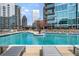 Rooftop pool with city views, lounge chairs, tables and seating with umbrellas at 1080 Peachtree Ne St # 2108, Atlanta, GA 30309