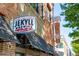 Jekyll Brewing company exterior with awnings, multiple signs, brick, and architectural details at 1202 Charleston Ct Cir, Woodstock, GA 30188