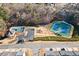 Aerial view of community amenities including a pool, tennis courts, playground and parking at 1202 Charleston Ct Cir, Woodstock, GA 30188