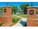 Attractive neighborhood entrance with brick pillars and manicured landscaping at 1202 Charleston Ct Cir, Woodstock, GA 30188