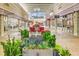 Outdoor outlet mall area with planters, benches, and many popular retail storefronts at 1202 Charleston Ct Cir, Woodstock, GA 30188