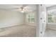 Bright, spacious carpeted bedroom with windows, and a ceiling fan, neutral walls, and carpet at 1202 Charleston Ct Cir, Woodstock, GA 30188