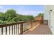 Wood deck with railing overlooking a green space and street at 1202 Charleston Ct Cir, Woodstock, GA 30188