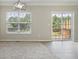 An open concept dining area with a view of a sliding glass door out to a wood deck and a large window at 1202 Charleston Ct Cir, Woodstock, GA 30188