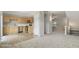 Open-concept kitchen seamlessly connects to the living area, featuring light wood cabinets and stainless steel appliances at 1202 Charleston Ct Cir, Woodstock, GA 30188