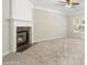 Spacious living area features a modern fireplace, neutral carpeting, and a ceiling fan at 1202 Charleston Ct Cir, Woodstock, GA 30188