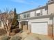 Townhome featuring attached garage, neutral siding, and well-maintained landscaping at 3972 Carlinswood Way, Stone Mountain, GA 30083