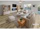 Bright living room features modern furniture, stylish decor, and beautiful wood-look flooring at 3972 Carlinswood Way, Stone Mountain, GA 30083