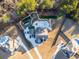 An aerial view displaying the home with manicured grounds including a pool, seating area, and a lawn at 149 Avalon Way, Sharpsburg, GA 30277