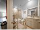 Well-lit bathroom featuring modern vanity with storage, a tub-shower combo and neutral color palette at 149 Avalon Way, Sharpsburg, GA 30277