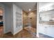 Elegant bathroom featuring a tiled shower with glass door and vanity with double sinks at 149 Avalon Way, Sharpsburg, GA 30277