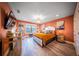 Unique main bedroom with orange walls, wood floors, large windows, and modern decor at 149 Avalon Way, Sharpsburg, GA 30277