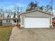 Charming single-story home with an attached garage, walkway to the entry, and landscaped front yard at 1641 Pendley Dr, Austell, GA 30168