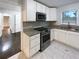 Modern kitchen featuring white cabinets, granite countertops, and stainless steel appliances at 1641 Pendley Dr, Austell, GA 30168