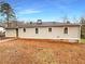 View of the back of the home, which features a sizable lawn and several windows at 1641 Pendley Dr, Austell, GA 30168