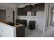 Bright kitchen space featuring sleek, dark cabinetry with an island ready for finishing touches at 1975 William Glen St, Dacula, GA 30019