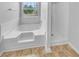 Bathroom featuring a corner tub, separate shower, and a window with a view at 3414 Bench Ave, Atlanta, GA 30349