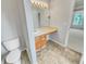 Bathroom featuring a vanity with a sink and cabinet storage, and light tile flooring at 3414 Bench Ave, Atlanta, GA 30349