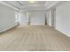 Bright and airy bedroom featuring a tray ceiling, neutral carpet, and several doors at 3414 Bench Ave, Atlanta, GA 30349