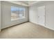 Bedroom with neutral carpet, a bright window overlooking the backyard, and a closet with double doors at 3414 Bench Ave, Atlanta, GA 30349