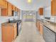 Well-lit kitchen with wood cabinets, modern appliances, a double sink, and a view of the breakfast area at 3414 Bench Ave, Atlanta, GA 30349