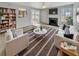 Bright and airy living room with a fireplace and neutral decor, virtually staged at 3414 Bench Ave, Atlanta, GA 30349