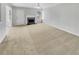 Bright living room featuring neutral carpet, a fireplace, a ceiling fan, and natural light from a window at 3414 Bench Ave, Atlanta, GA 30349