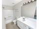 Clean bathroom with a white vanity, large mirror, shower-tub, and updated fixtures at 61 Barrington Pl, Marietta, GA 30066