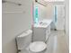 Bright bathroom featuring a white vanity, sink, large mirror, and neutral-toned tile flooring at 61 Barrington Pl, Marietta, GA 30066