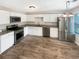 Modern kitchen with stainless steel appliances, granite countertops, and ample cabinet space at 61 Barrington Pl, Marietta, GA 30066