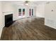 Spacious living room filled with light, hardwood floors, fireplace, and patio access at 61 Barrington Pl, Marietta, GA 30066