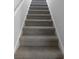 Carpeted staircase featuring neutral tones and a minimalist design at 61 Barrington Pl, Marietta, GA 30066