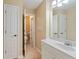 Bathroom with white vanity and view to toilet behind an open door at 3130 Kates Nw Way, Kennesaw, GA 30152