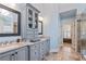 Bright bathroom featuring double sink vanity, granite counters, and a glass enclosed shower at 3130 Kates Nw Way, Kennesaw, GA 30152