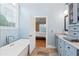 Bathroom featuring soaking tub, natural light, and view to main bedroom at 3130 Kates Nw Way, Kennesaw, GA 30152