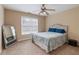 Neutral bedroom with ceiling fan, carpet, and bed with blue pillows at 3130 Kates Nw Way, Kennesaw, GA 30152