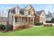 Charming home featuring stone and siding accents, manicured lawn, and a welcoming front porch at 3130 Kates Nw Way, Kennesaw, GA 30152