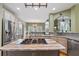 Bright kitchen featuring stainless steel appliances, granite countertops, a gas cooktop island, and natural wood cabinets at 3130 Kates Nw Way, Kennesaw, GA 30152