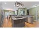 Spacious kitchen with stainless steel appliances, a gas cooktop island, natural wood cabinets, and hardwood floors at 3130 Kates Nw Way, Kennesaw, GA 30152