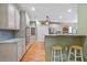 Modern kitchen with stainless appliances, light wood cabinets, hardwood floors and tiled backsplash at 3130 Kates Nw Way, Kennesaw, GA 30152
