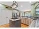 Well-lit kitchen with stainless steel appliances, a gas cooktop island, light wood cabinets, and hardwood floors at 3130 Kates Nw Way, Kennesaw, GA 30152