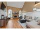 Inviting living room featuring a stone fireplace, large windows, and hardwood floors at 3130 Kates Nw Way, Kennesaw, GA 30152