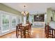 Open floor plan connecting the breakfast area and living room with abundant natural light and hardwood floors at 3130 Kates Nw Way, Kennesaw, GA 30152