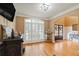 Inviting living room with hardwood floors, plantation shutters, and a custom bar with barrel accents at 3130 Kates Nw Way, Kennesaw, GA 30152