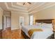 Inviting main bedroom boasting hardwood floors, tray ceilings, and an en-suite bathroom at 3130 Kates Nw Way, Kennesaw, GA 30152